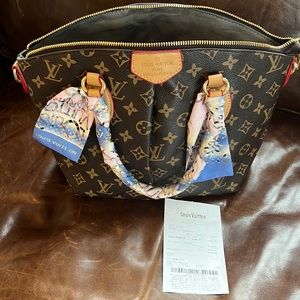 Louis Vuitton style bag with a scarf.